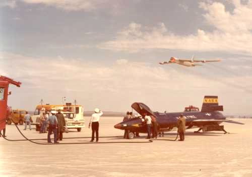X-15 on lakebed after landing, B-52 flyover